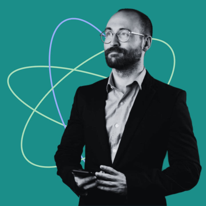 man with phone in hand looking into the distance am atom shape in the background